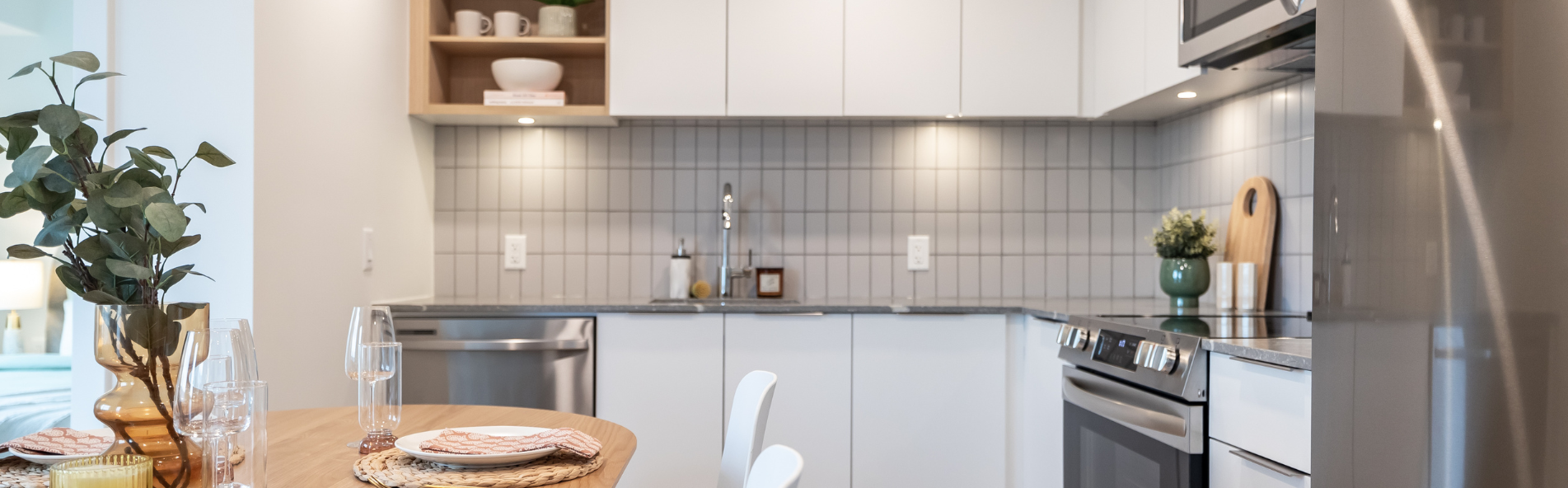 Modern kitchen with stainless steel appliances at The Hyland. Rent with Minto Apartments.